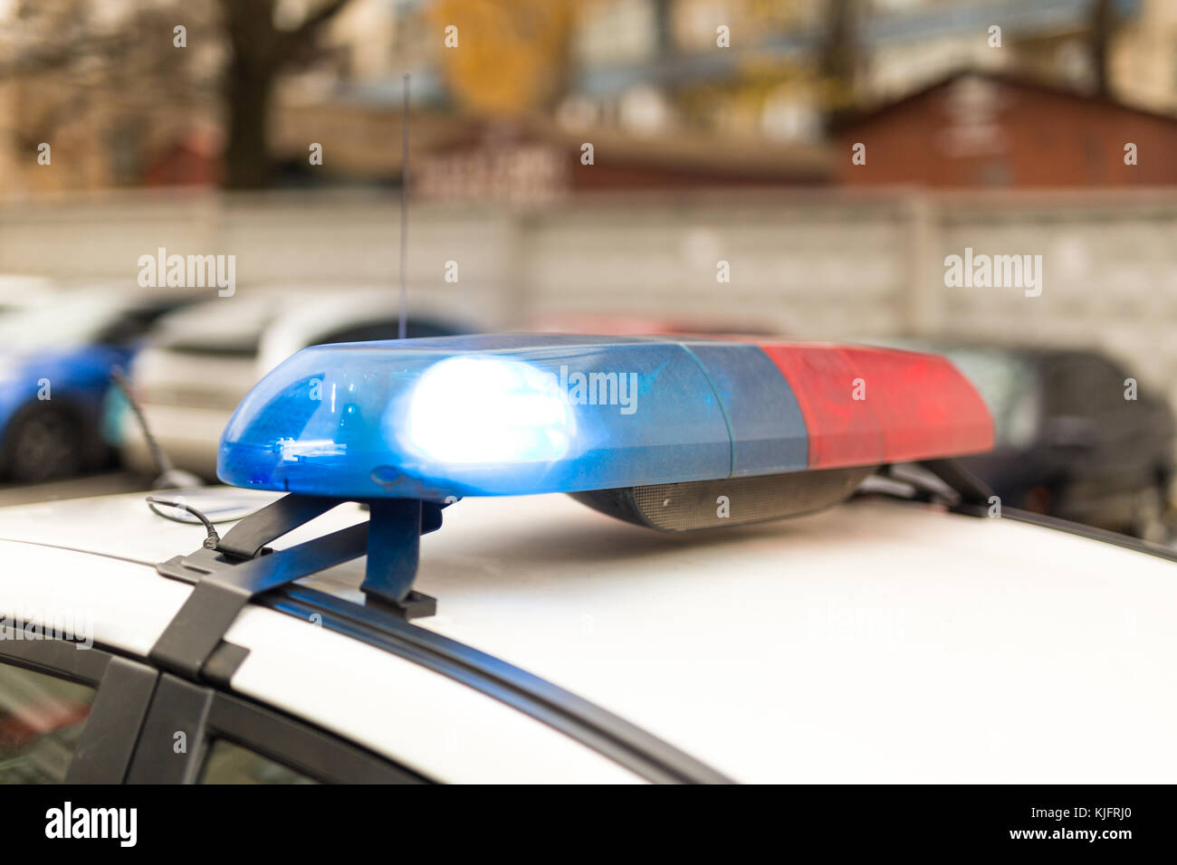 Roof of a poliƱe patrol car with flashing blue and red lights, sirens