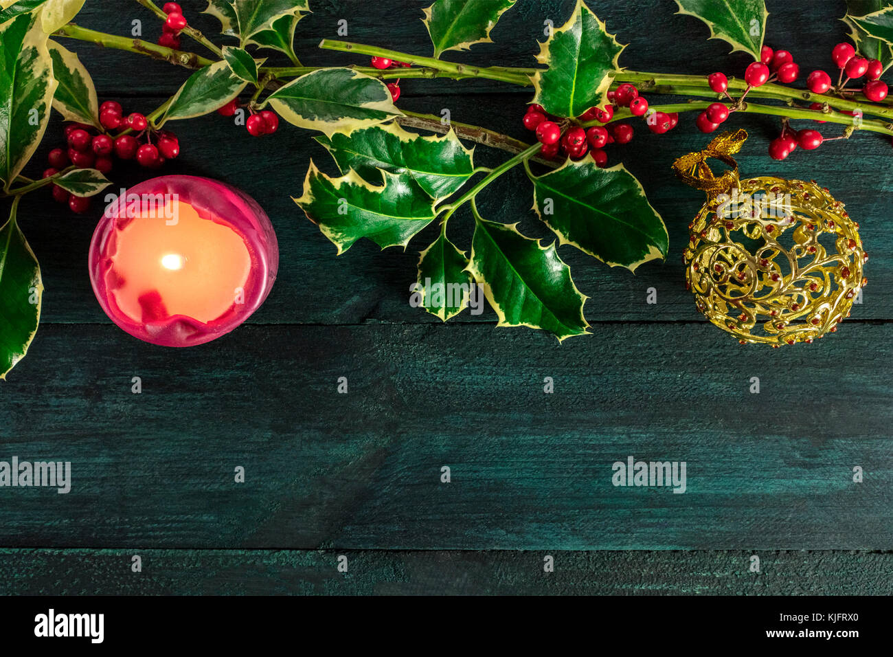 Christmas template with holly branches, candle, and copy space Stock ...