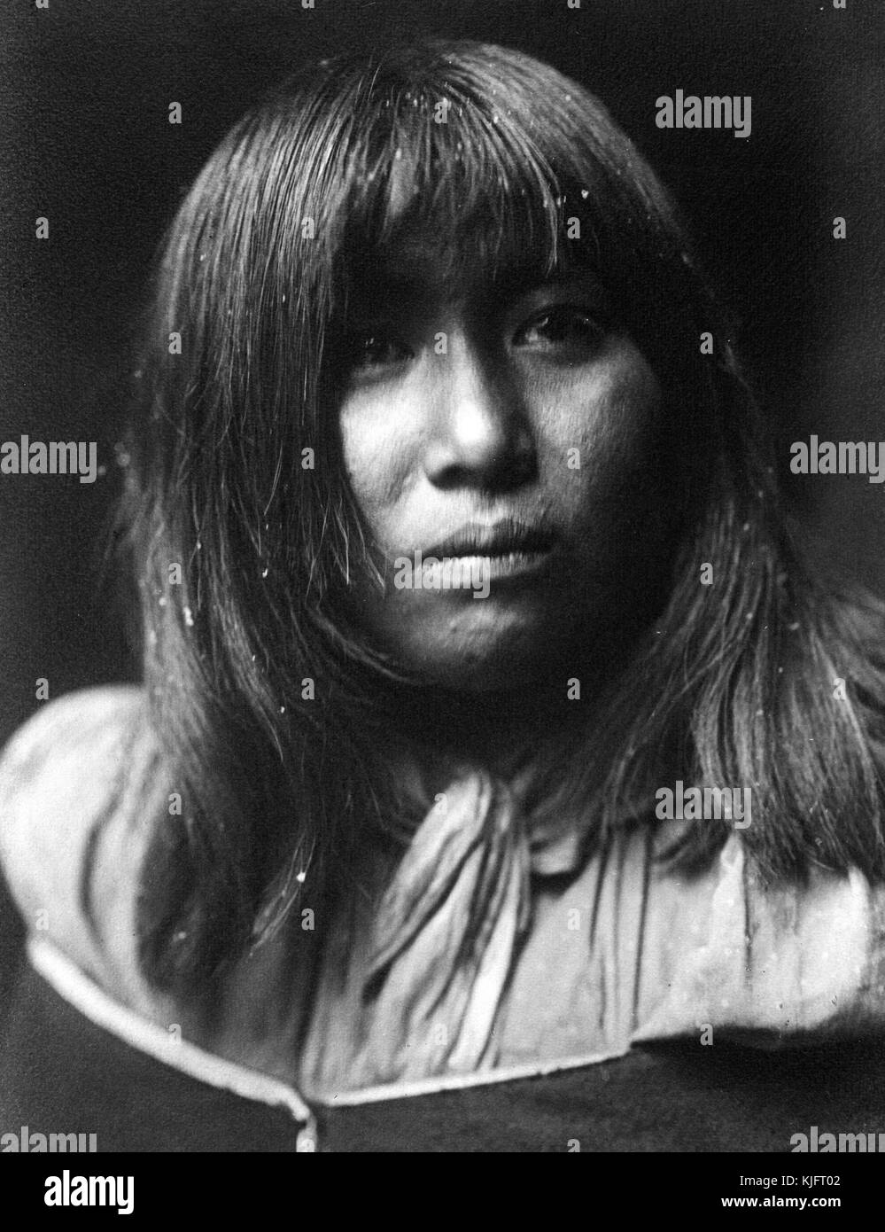 A photographic portrait of a woman belonging to the Hualapai Native American tribe, the tribe is also known as the Walapai, she had shoulder length black hair and wore a wrap over her dress, 1907. From the New York Public Library. Stock Photo