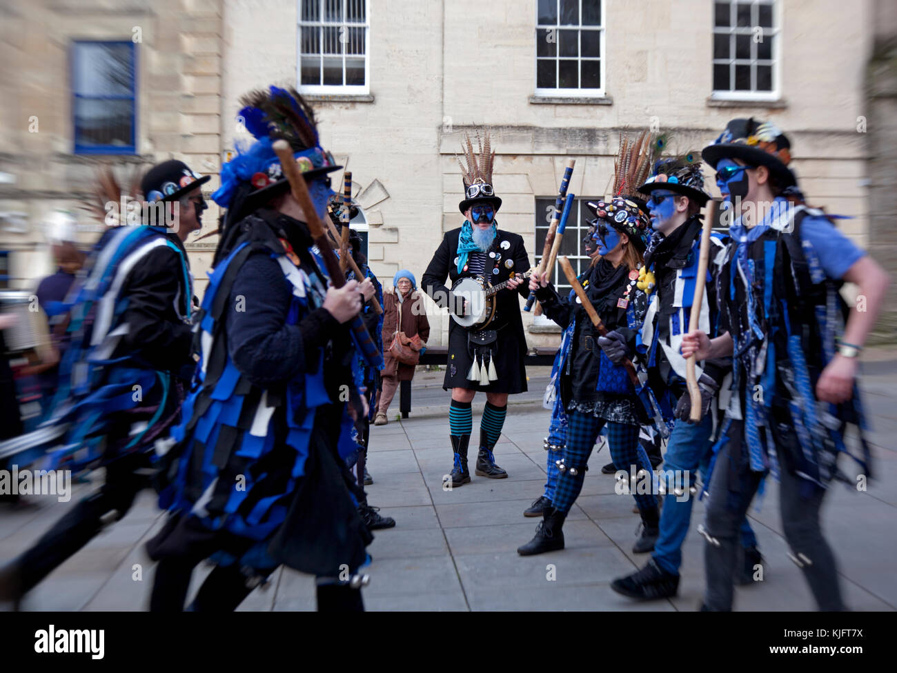 Morris dancers with blue face disguises entertain during the Stroud wassail outside the Cotswold town hall Stock Photo