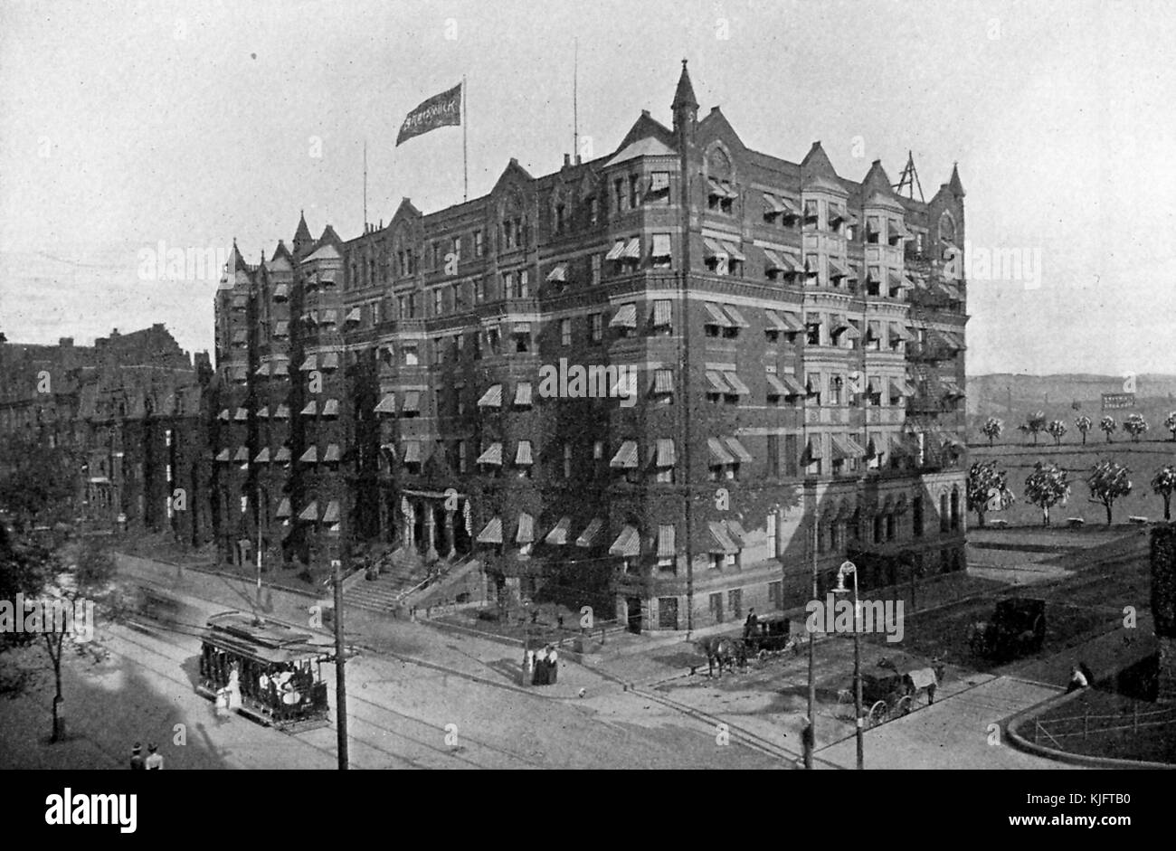A exterior photograph of Hotel Brunswick, the hotel was well known for having United States Presidents, diplomats, world leaders, and celebrities stay there, people can be seen walking on the sidewalks, riding a trolley, and riding in horse drawn carriages around the hotel, the six story building was torn down in the 1950's, Boston, Massachusetts, 1913. Stock Photo