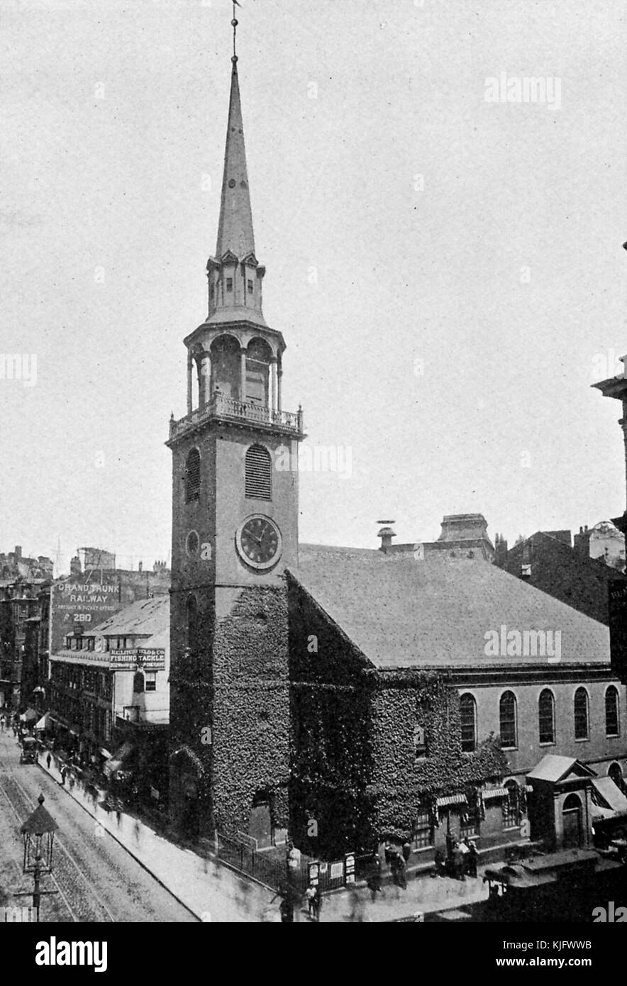 An exterior photograph of Old South Meeting House, the historic church was completed in 1729, it was the meeting place for the organization of the Boston Tea Party, at the time it was the largest building in the city, the blurred outlines of people can be seen on the street in this long exposure, Boston, Massachusetts, 1905. Stock Photo