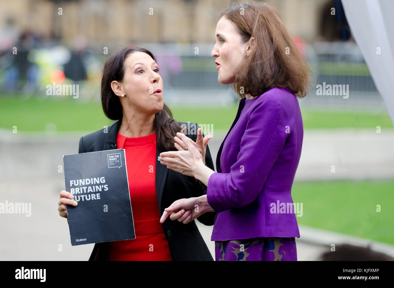 Debbie Abrahams MP (Labour; Oldham East and Saddleworth) and Theresa Villiers MP (Con: Chipping Barnet) on College Green, Westminster arguing about.. Stock Photo