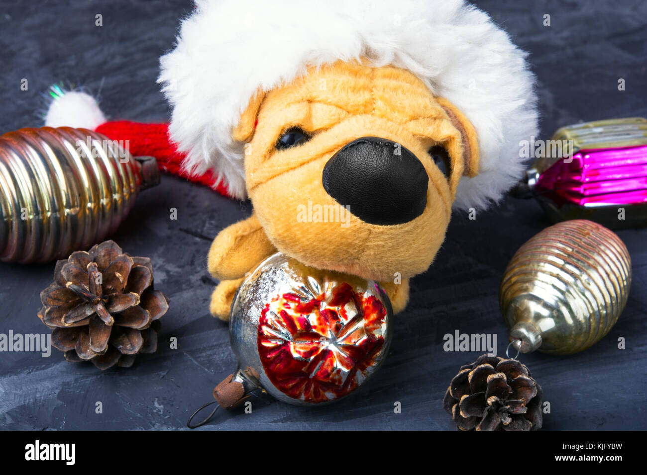 Symbolic Puppy Of A Dog In Christmas Decorations Stock Photo
