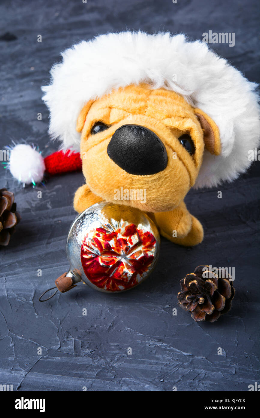 Symbolic Puppy Of A Dog In Christmas Decorations Stock Photo