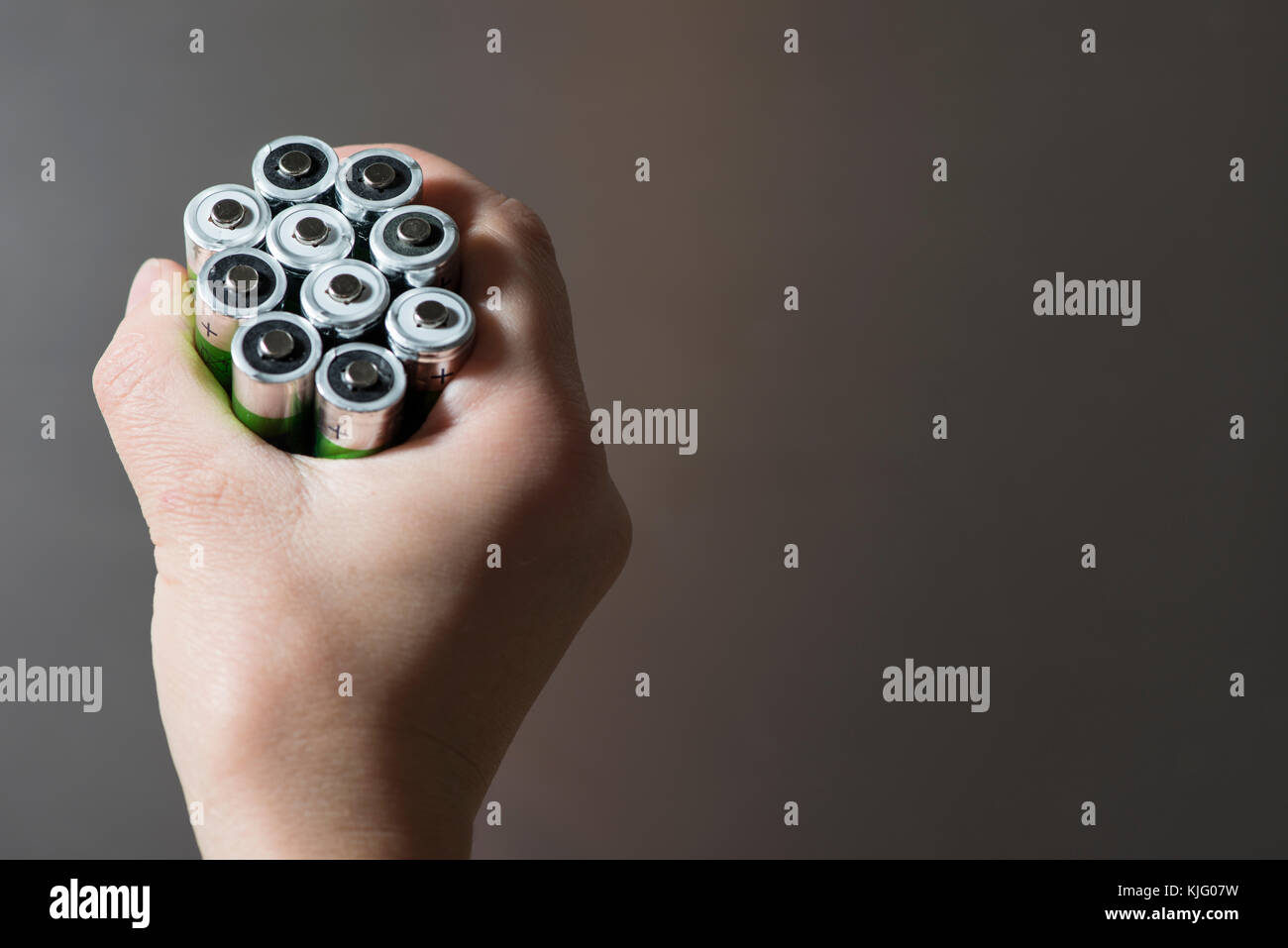 Hand hold many batteries. Close up Stock Photo