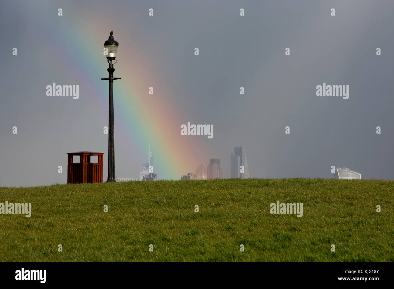 Rainbow and distant view of the City of London from Primrose Hill, London, UK Stock Photo