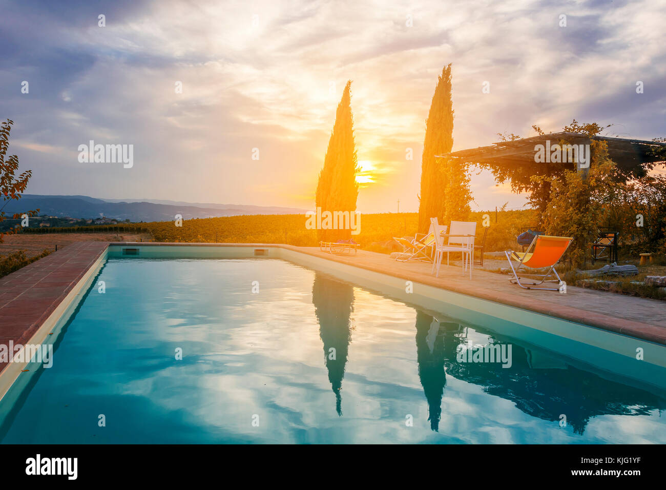 sunset over a pool in italian countryside Stock Photo