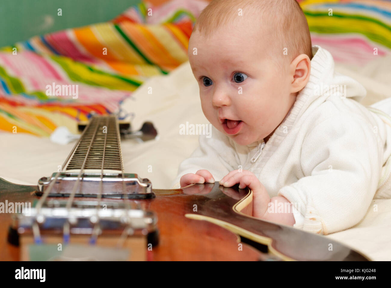 Four month baby girl and the bass guitar Stock Photo