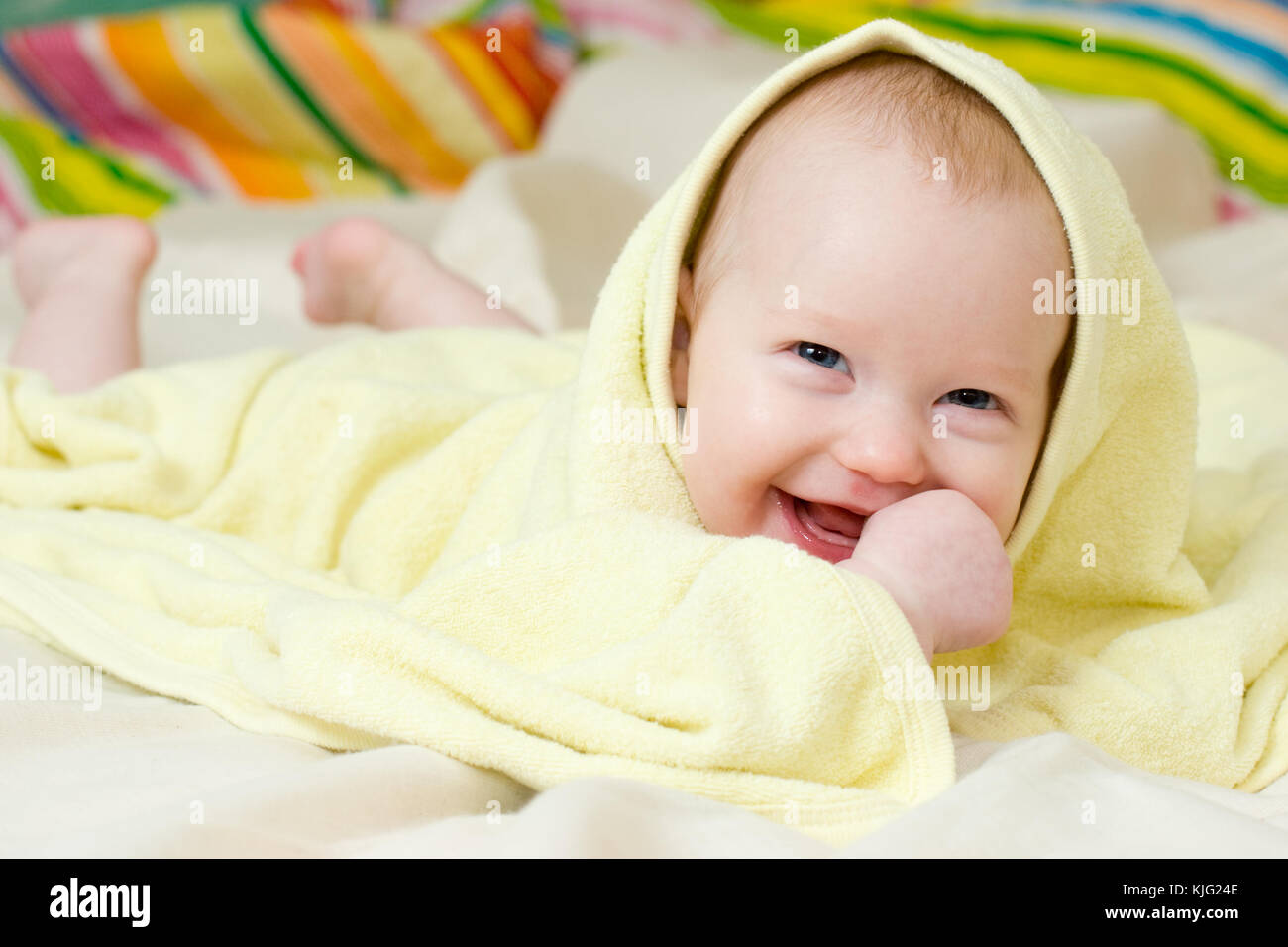 Happy four month baby girl in towel Stock Photo Alamy