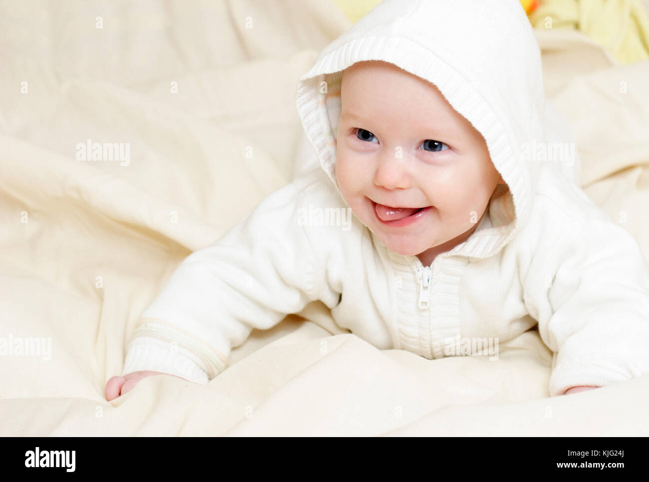Happy four month baby girl wearing hood Stock Photo Alamy