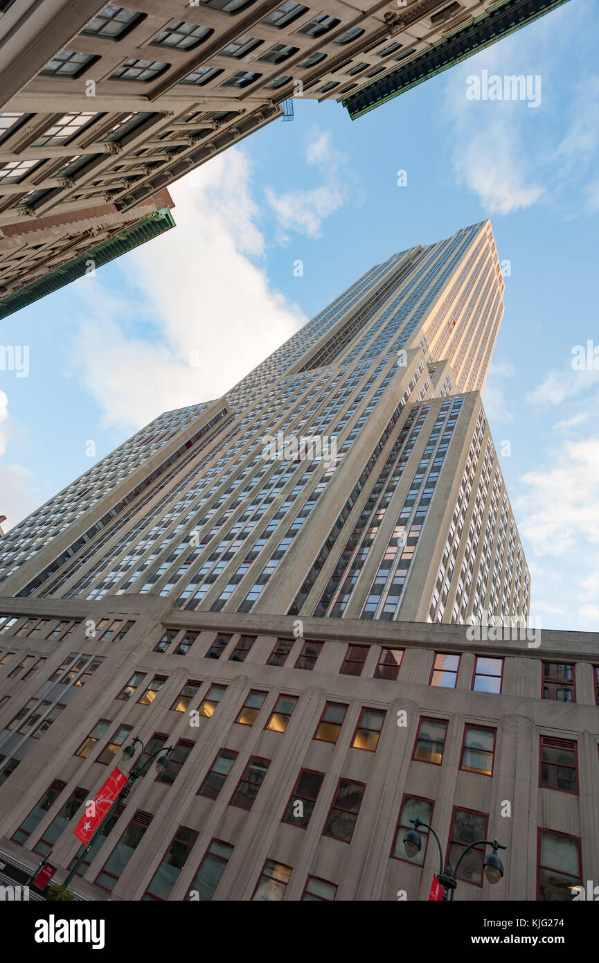 Empire State building low vertical view against blue sky Stock Photo
