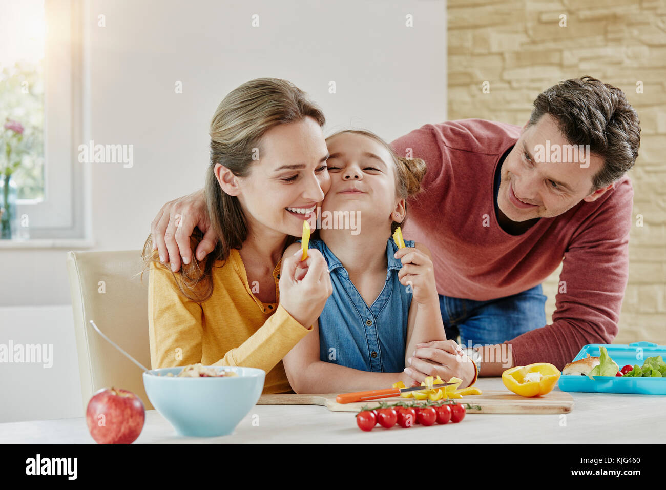 Happy family at home preparing healthy food Stock Photo