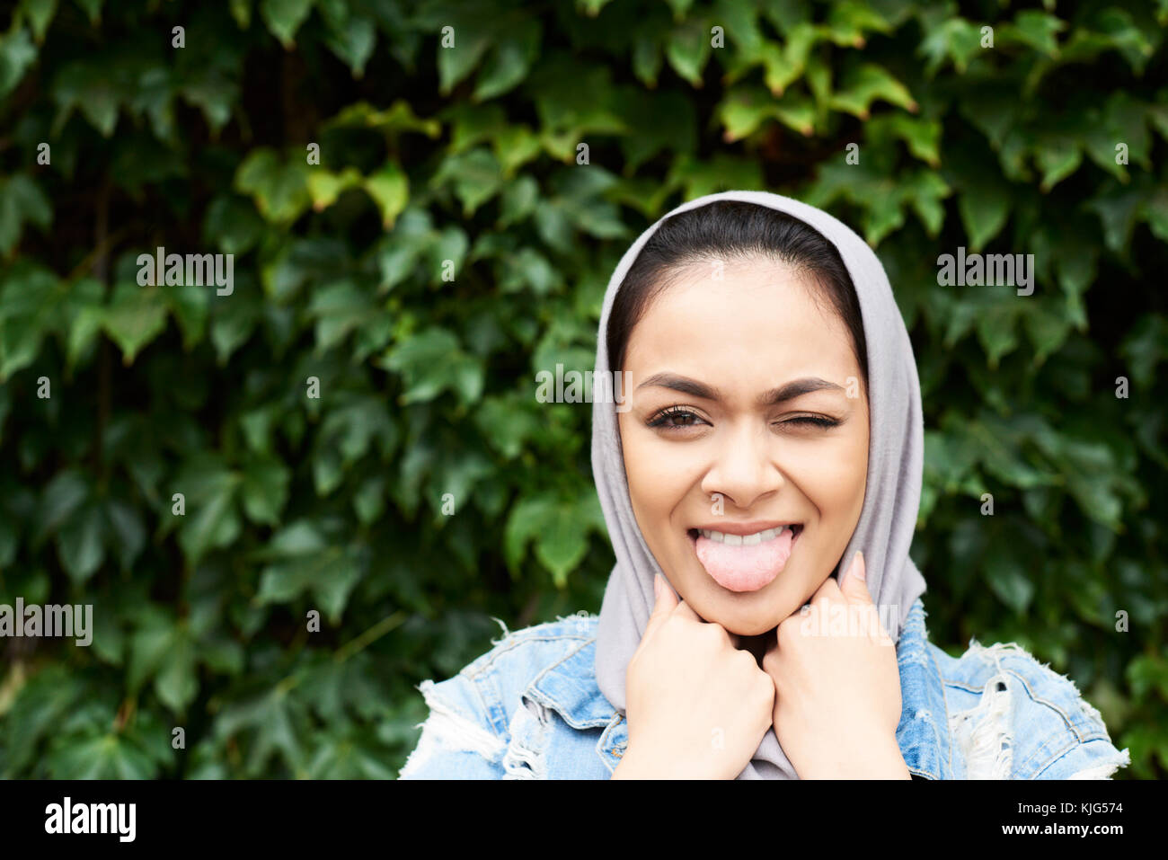 London, UK, England, Portrait of a beautiful muslim girl wearing hijab smiling happy at camera, muslim university student Stock Photo