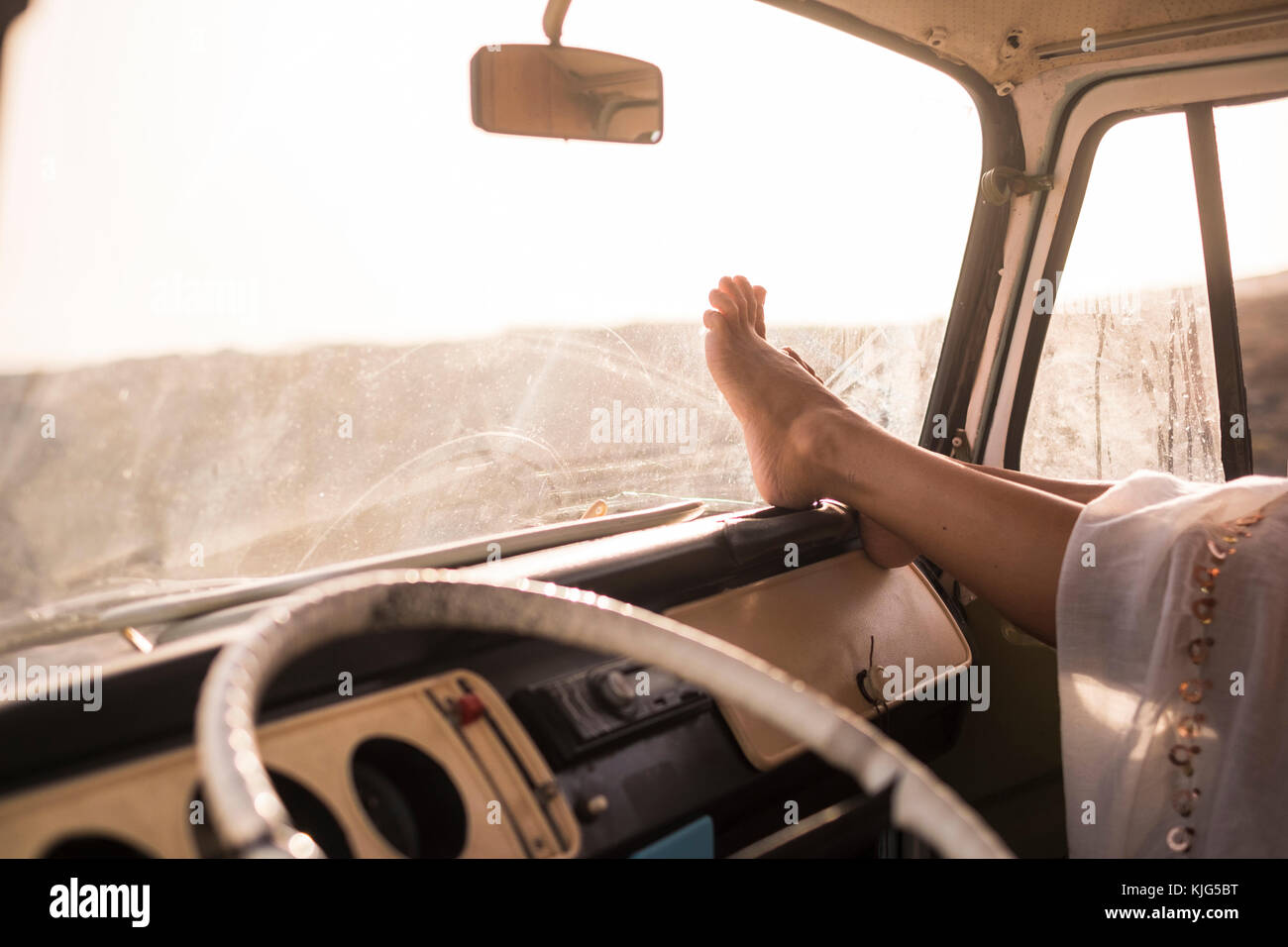 Woman sitting in car with feet up on dashboard Stock Photo Alamy