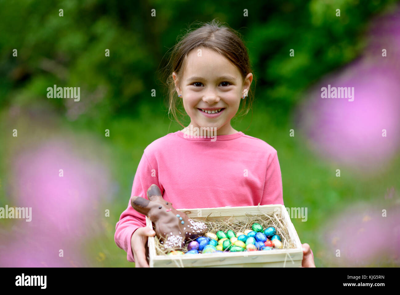 Mädchen hält ein Osternest, Korb mit Ostereiern,  Osterkorb in den Händen, Ostereier Suchen, Ostern, Bayern, Deutschland Stock Photo