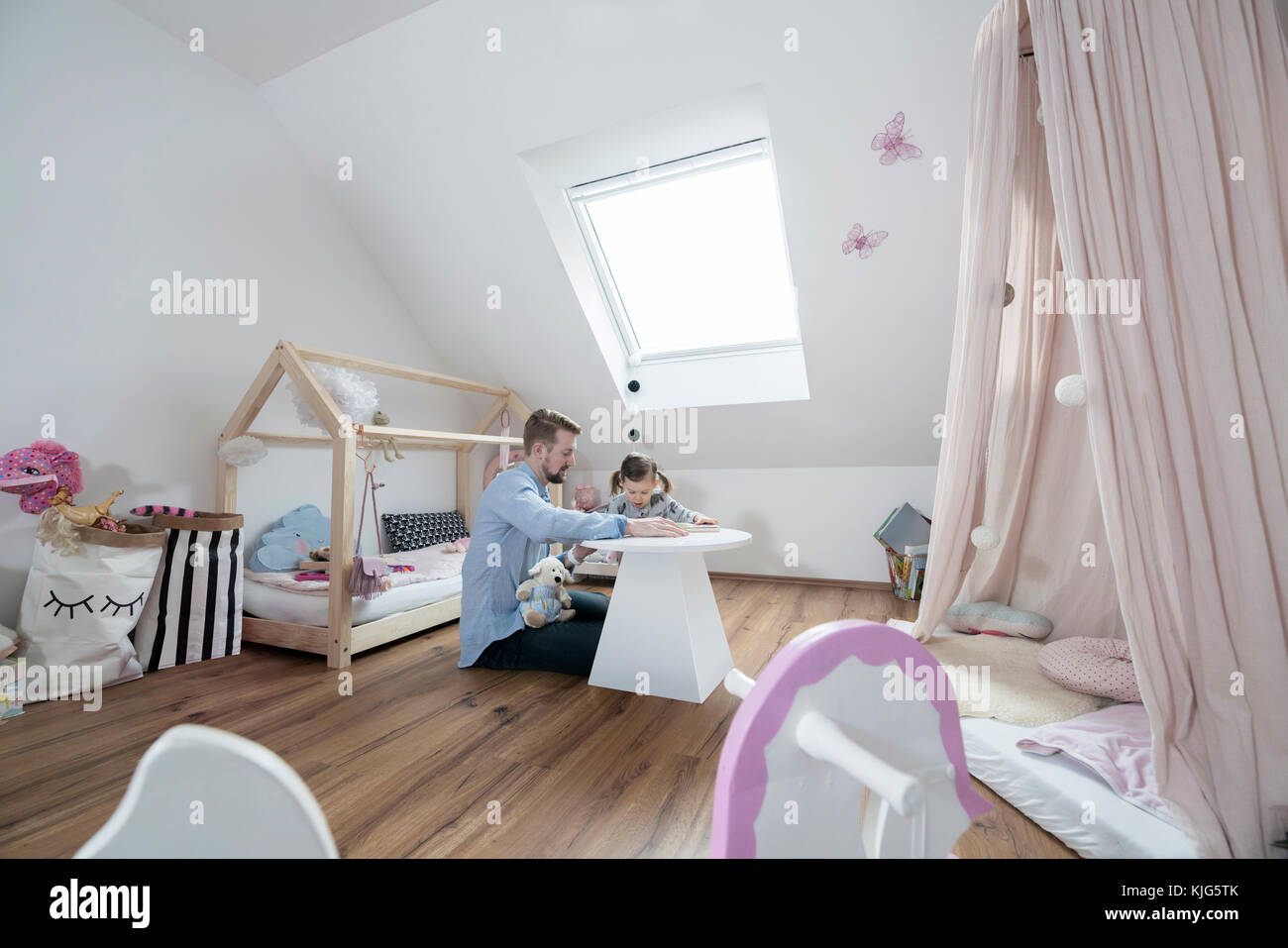 Father and daughter in her nursery Stock Photo