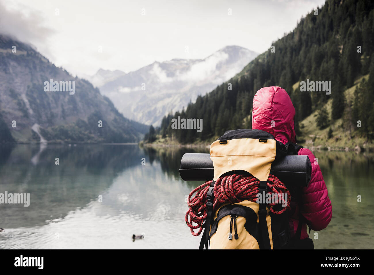 Austria, Tyrol, Alps, hiker standing at mountain lake Stock Photo - Alamy
