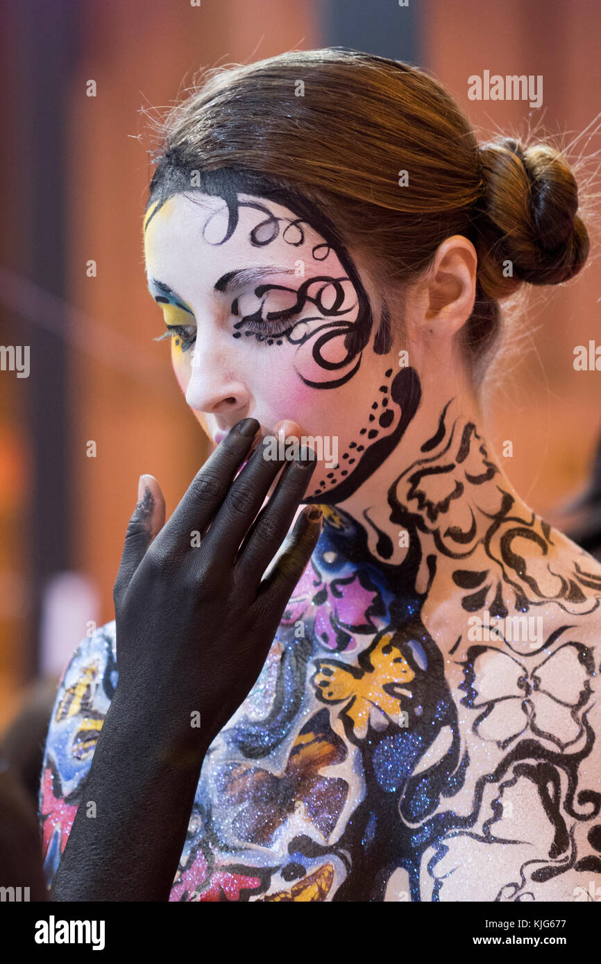 Portrait image of a body painting model hiding her mouth in Salon Look Madrid 2017. Stock Photo