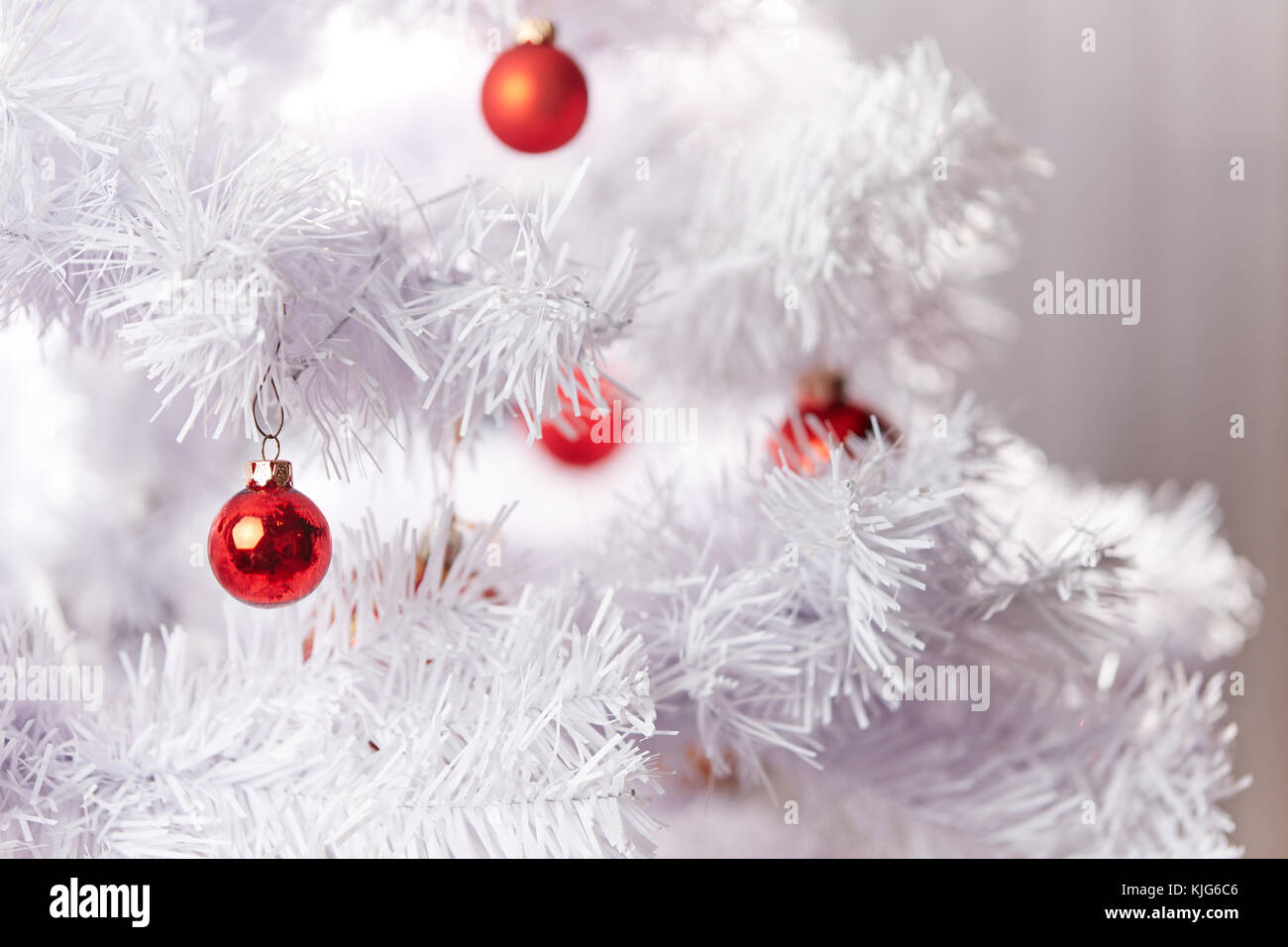 Red and Golden Christams Balls hanging on the white branches of a ...