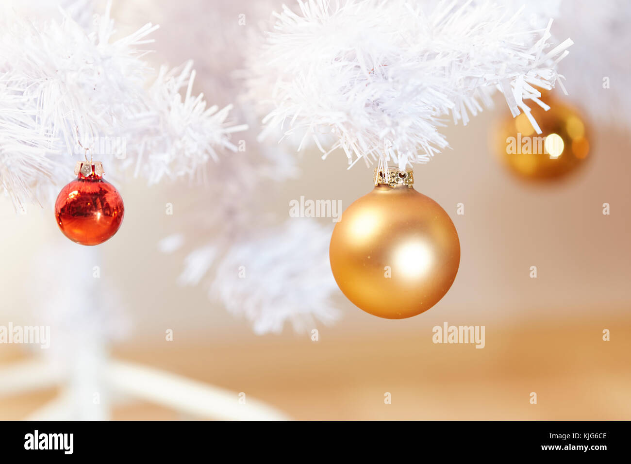 Red and Golden Christams Balls hanging on the white branches of a ...
