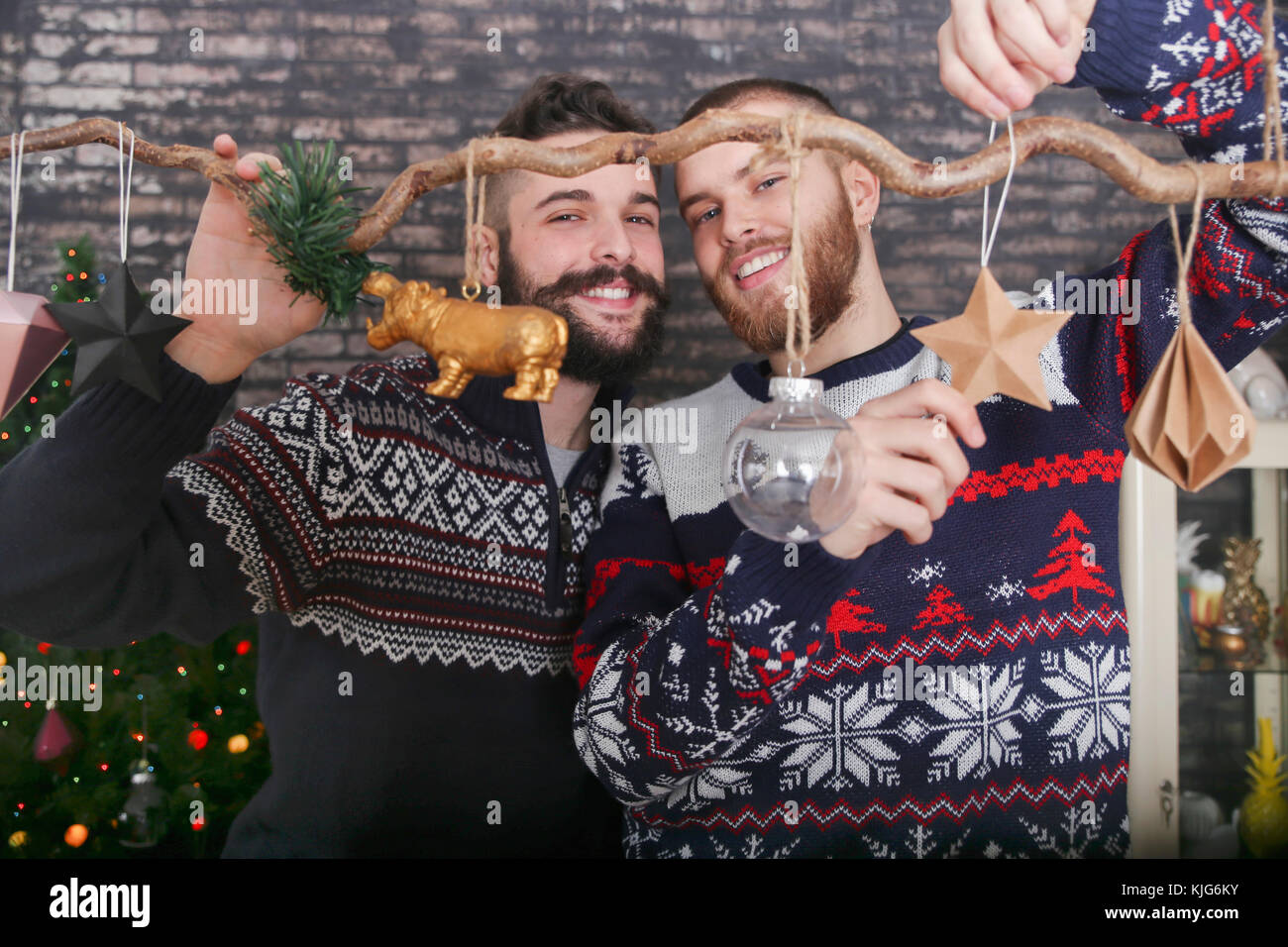 Gay couple decorating a branch at Christmas time Stock Photo