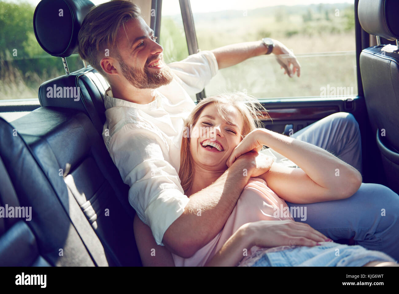 Affectionate couple having a fun during car trip, Krakow, Malopolskie, Poland Stock Photo