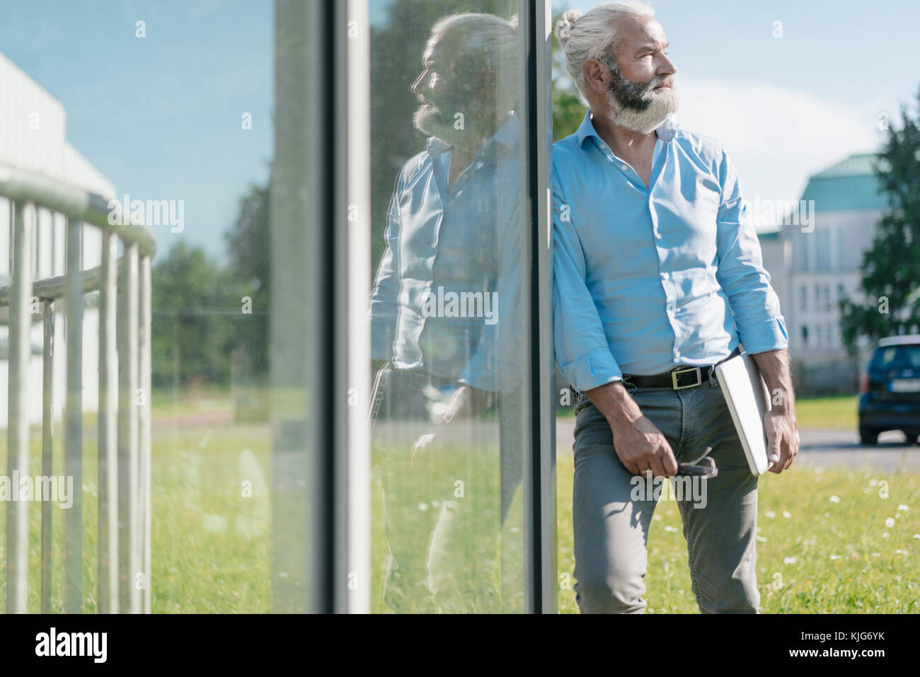 [a man standing holding hi-res stock photography and images - Alamy