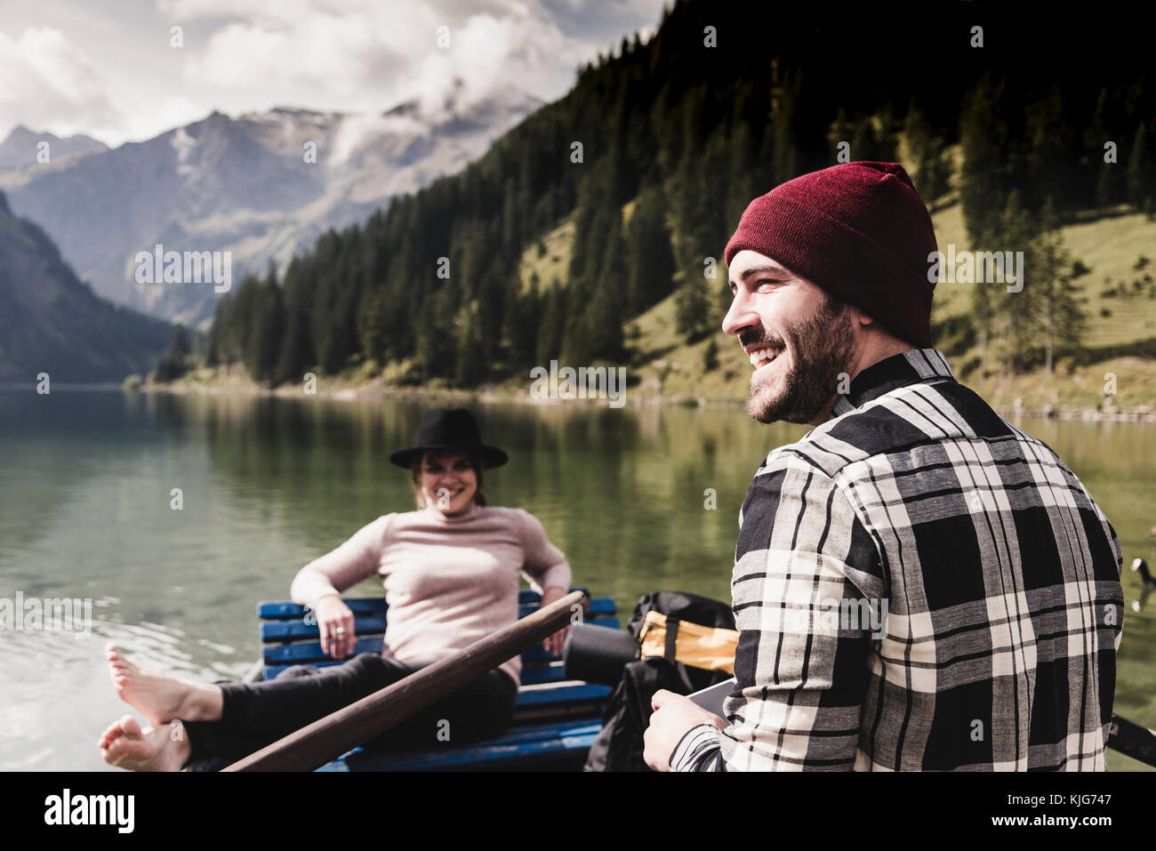 Austria, Tyrol, Alps, happy couple in rowing boat on mountain lake Stock Photo