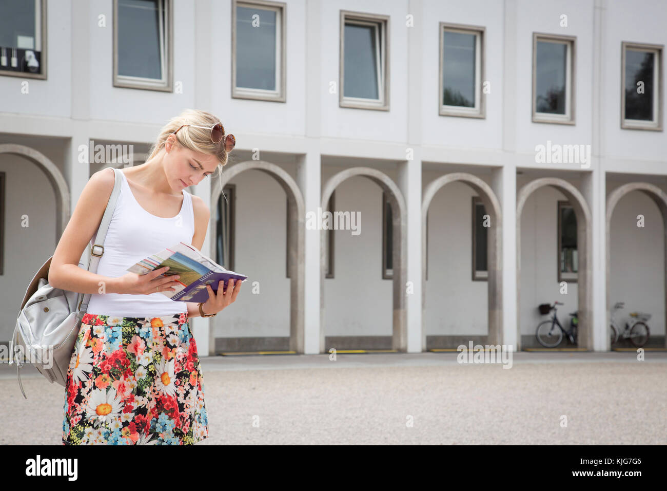 Germany, Karlsruhe, tourist looking at tour guide Stock Photo