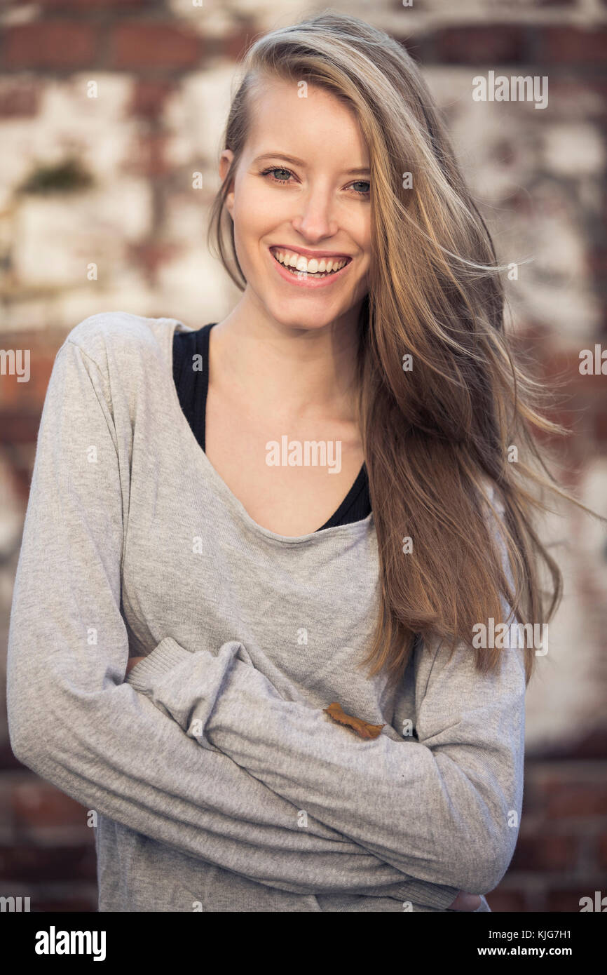 Portrait of laughing woman with armes crossed Stock Photo