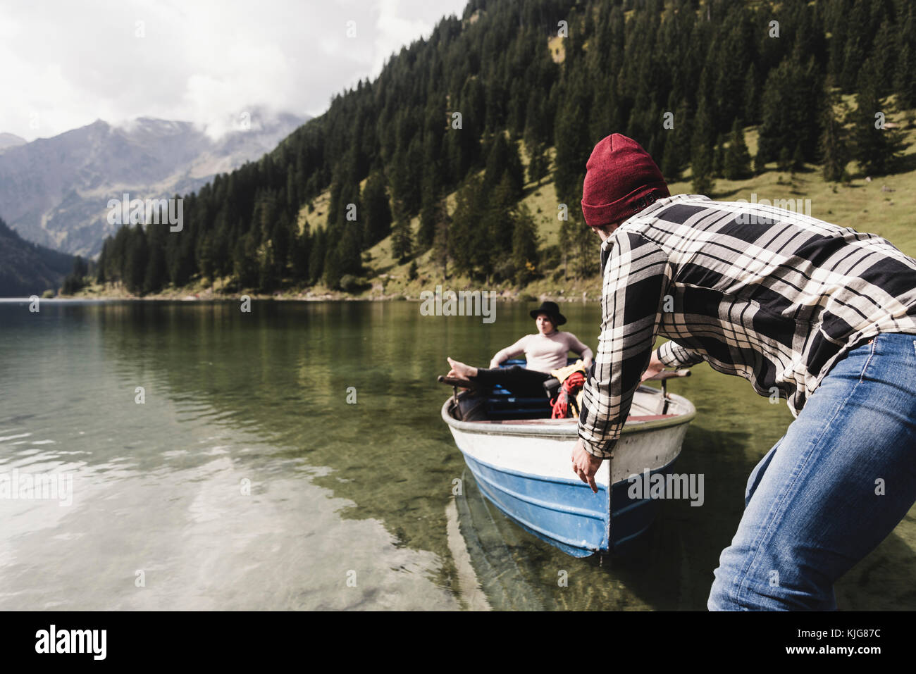 Austria, Tyrol, Alps, couple with rowing boat on mountain lake Stock Photo