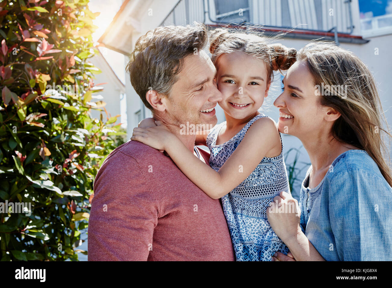 Portrait of happy family in front of their home Stock Photo