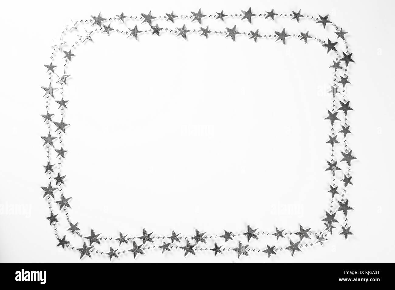 Christmas frame with silver stars decorations on white background. Simple Christmas composition with free space Stock Photo