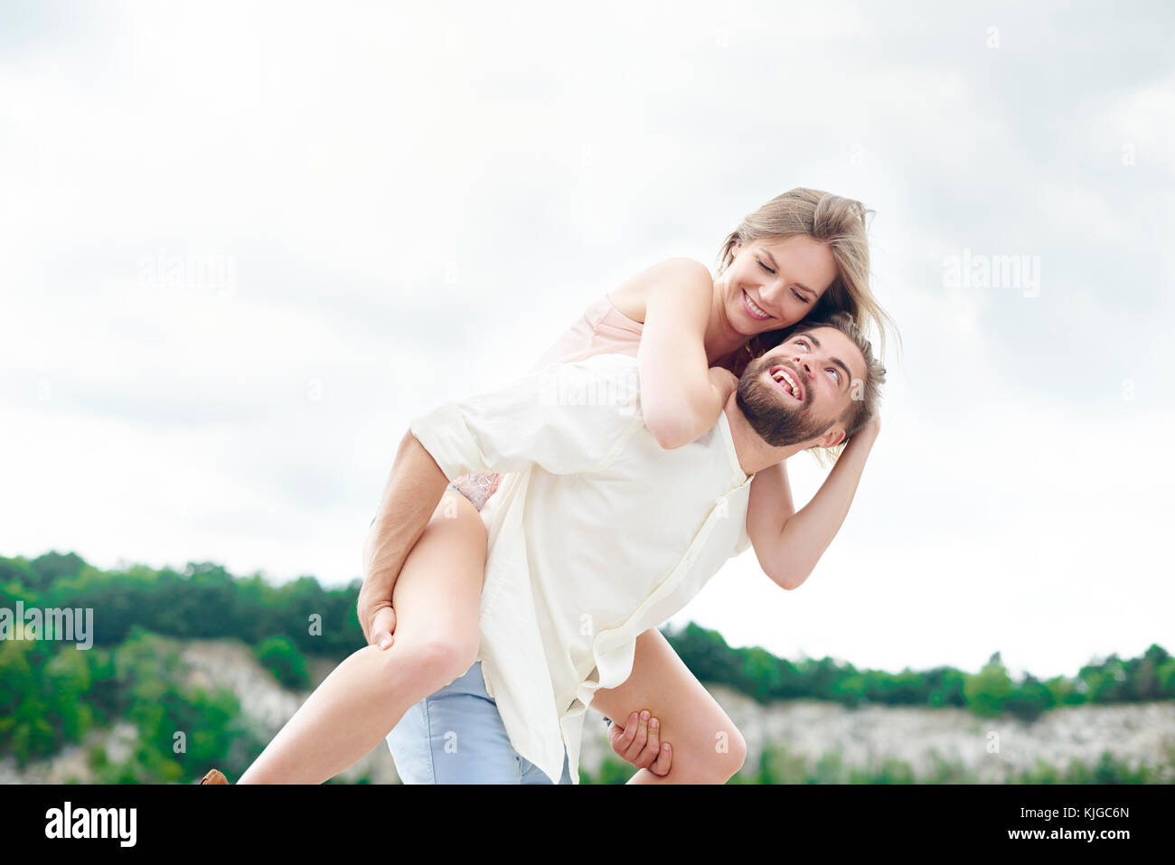 Man giving his girlfriend piggyback, Krakow, Malopolskie, Poland Stock Photo
