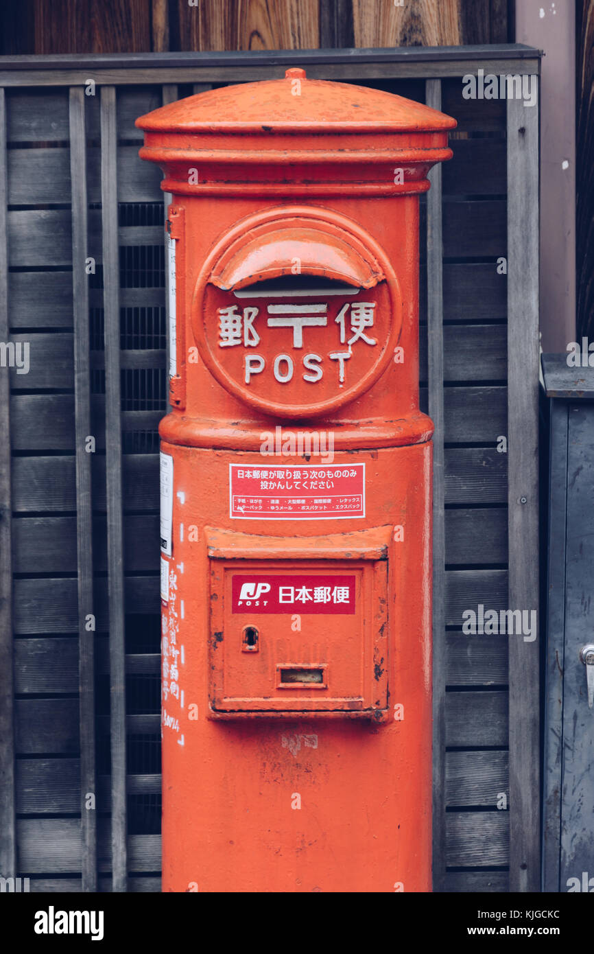 An orange postbox in the backstreets of Kyoto, Japan. Stock Photo