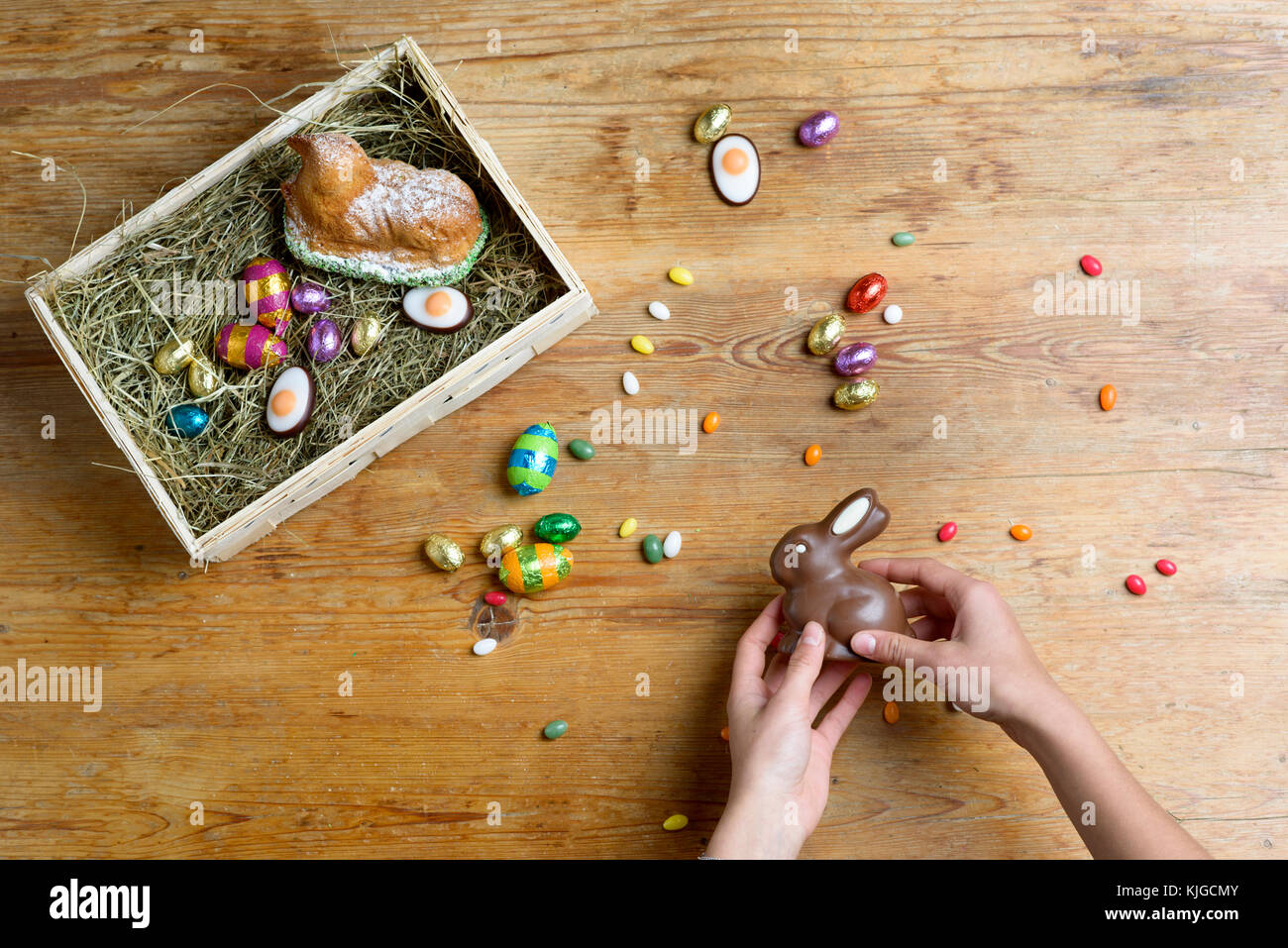 Hands filling Easter nest Stock Photo - Alamy