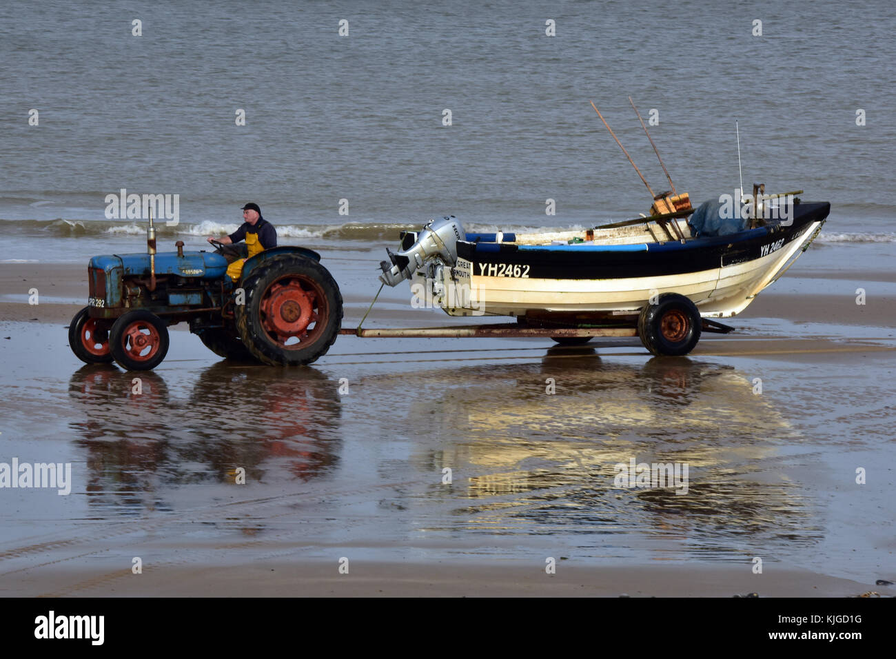 a traditional Cromer crab fisherman towing his fishing boat along the