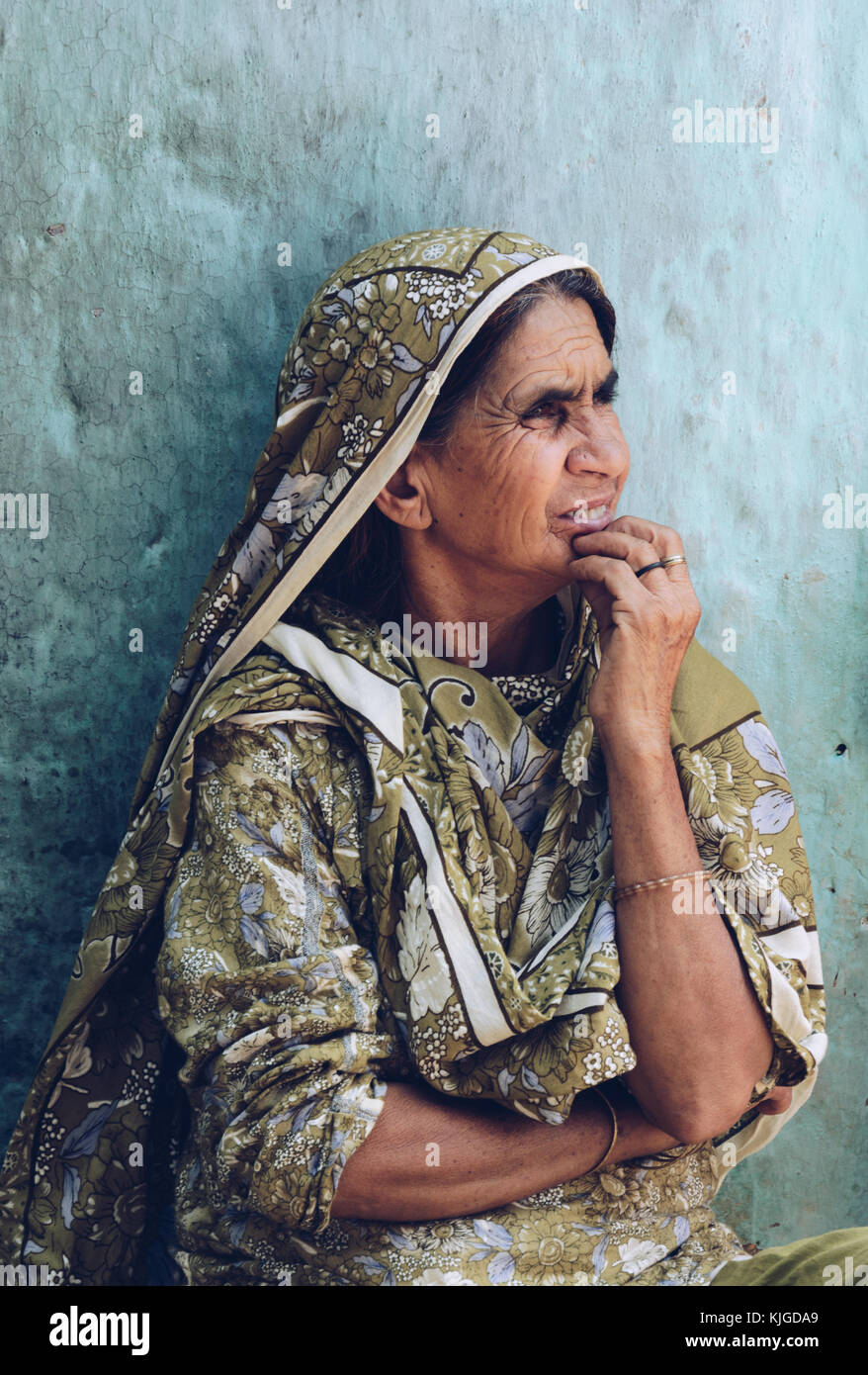A woman watches children play in a remote village in the Murree Hills, Punjab, Pakistan. Stock Photo