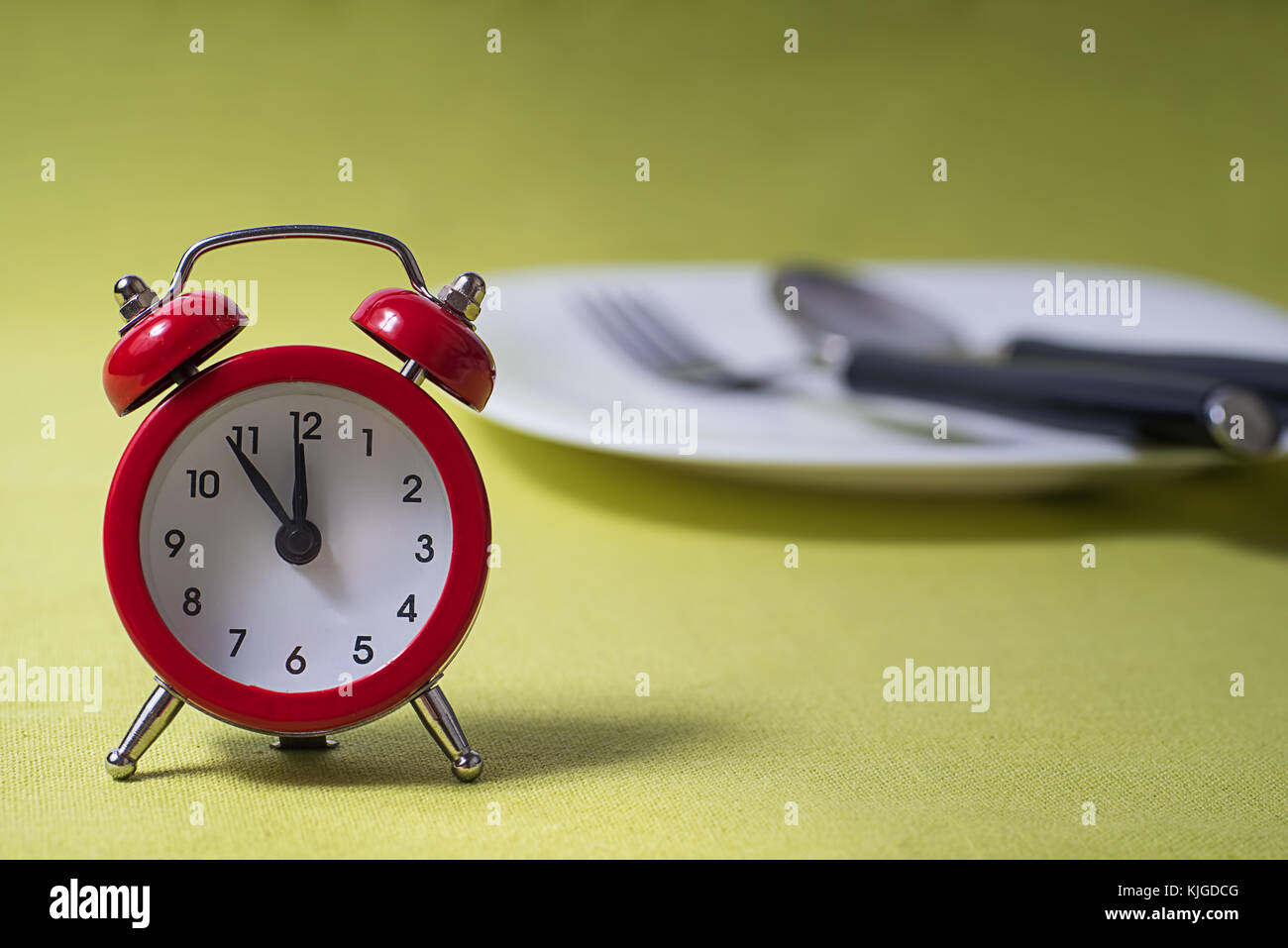 Time to eat concept, clock on plate Stock Photo Alamy