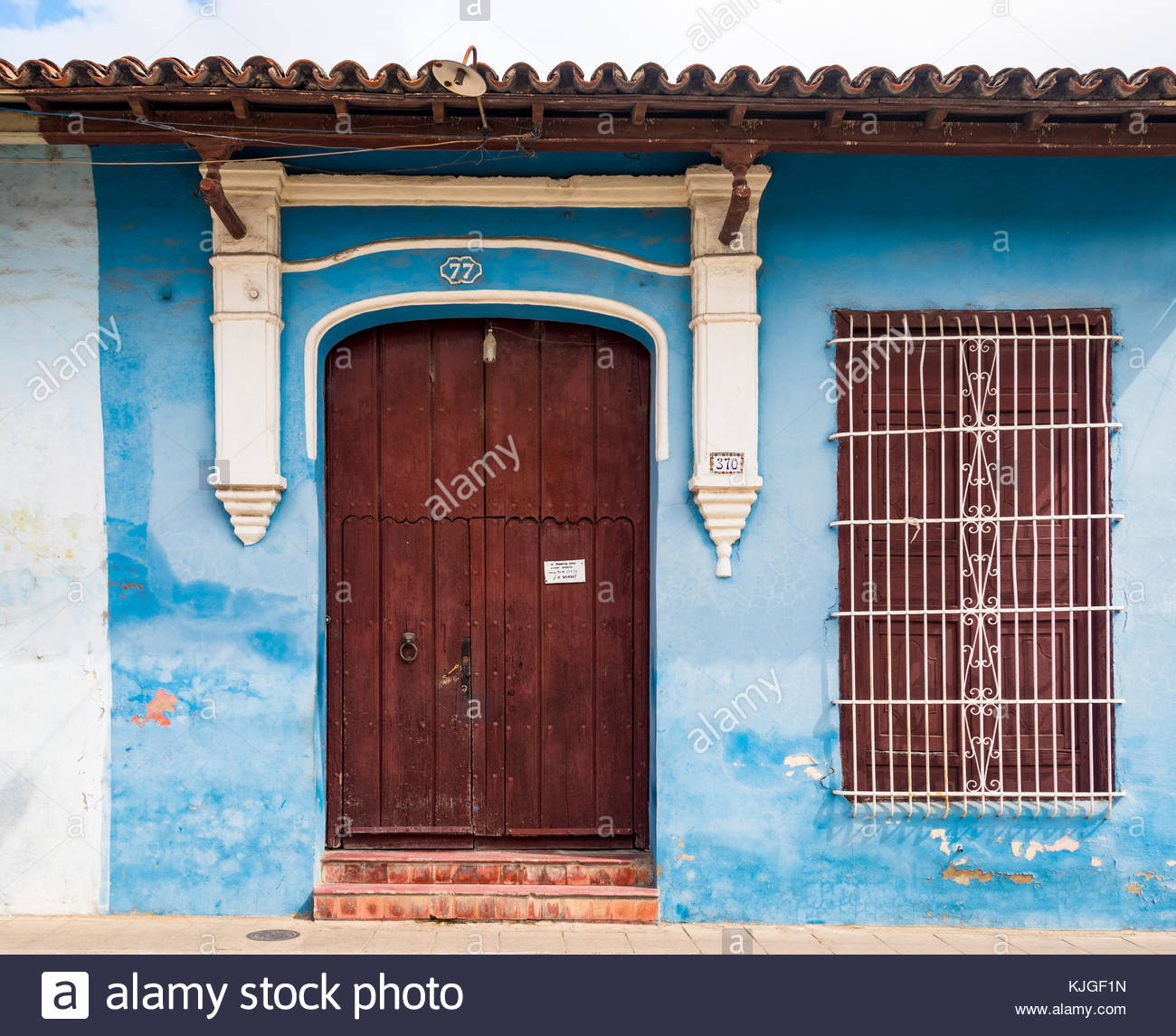 Front Of An Old House Brown Wooden Door With White