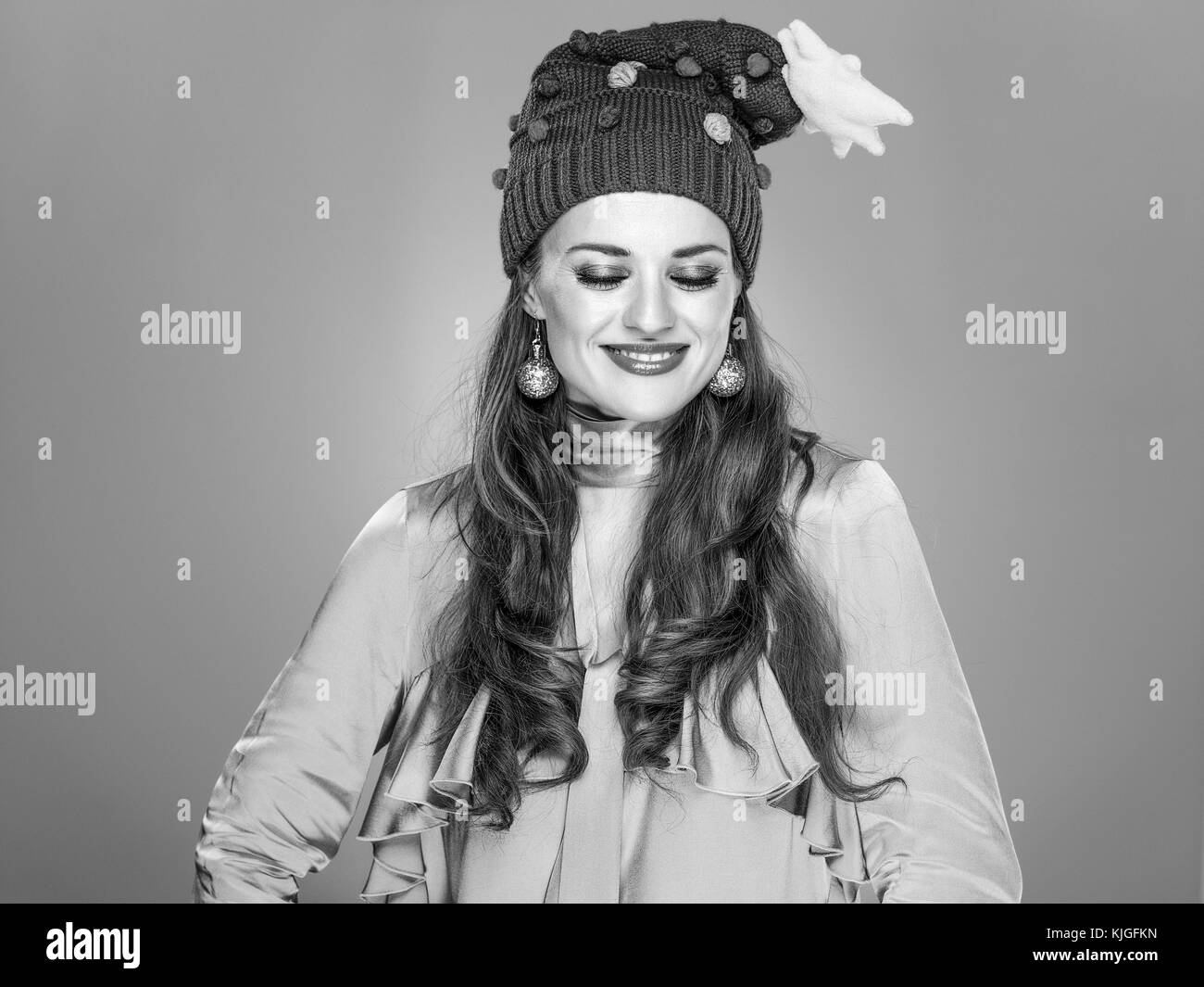 Stunning season. Portrait of happy stylish woman in funny Christmas hat isolated on grey Stock Photo