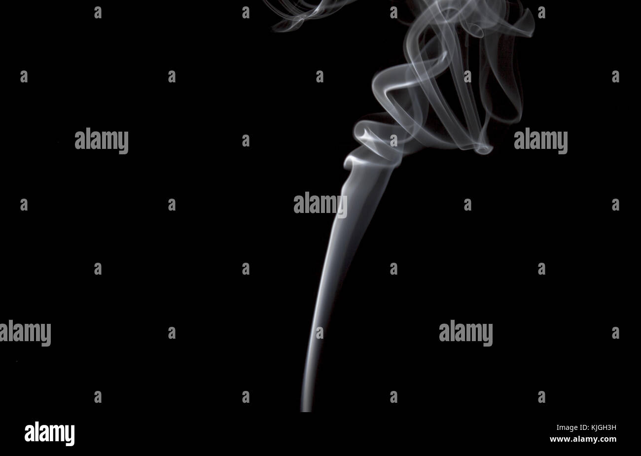 Smoke volutes on a pure black background Stock Photo - Alamy