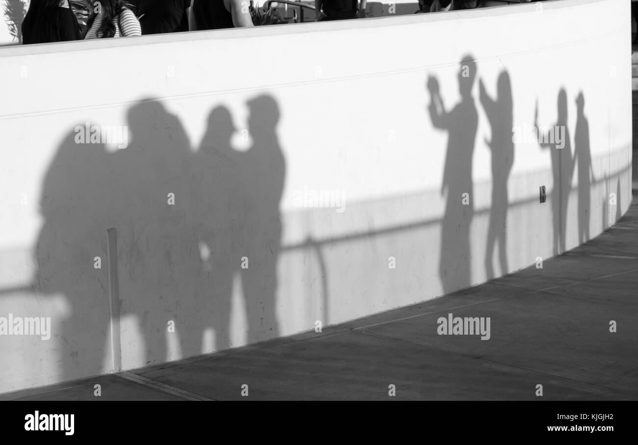 Dark outline shadows cast onto a facade by the sun near sunset Stock Photo