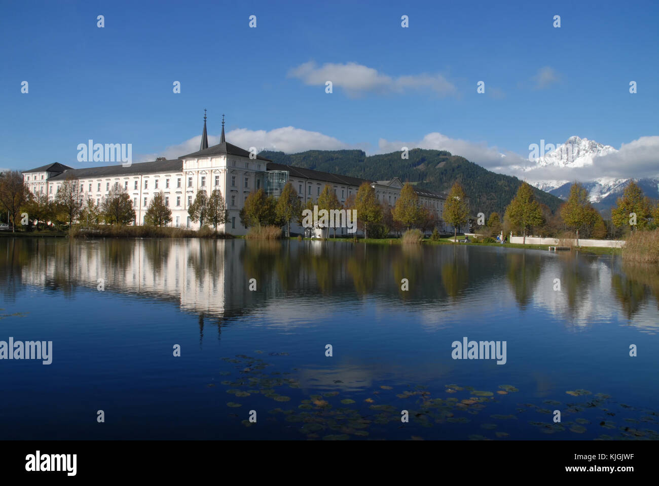 Reflection of Admont Abbey, Austria, and snow covered mountains Stock Photo