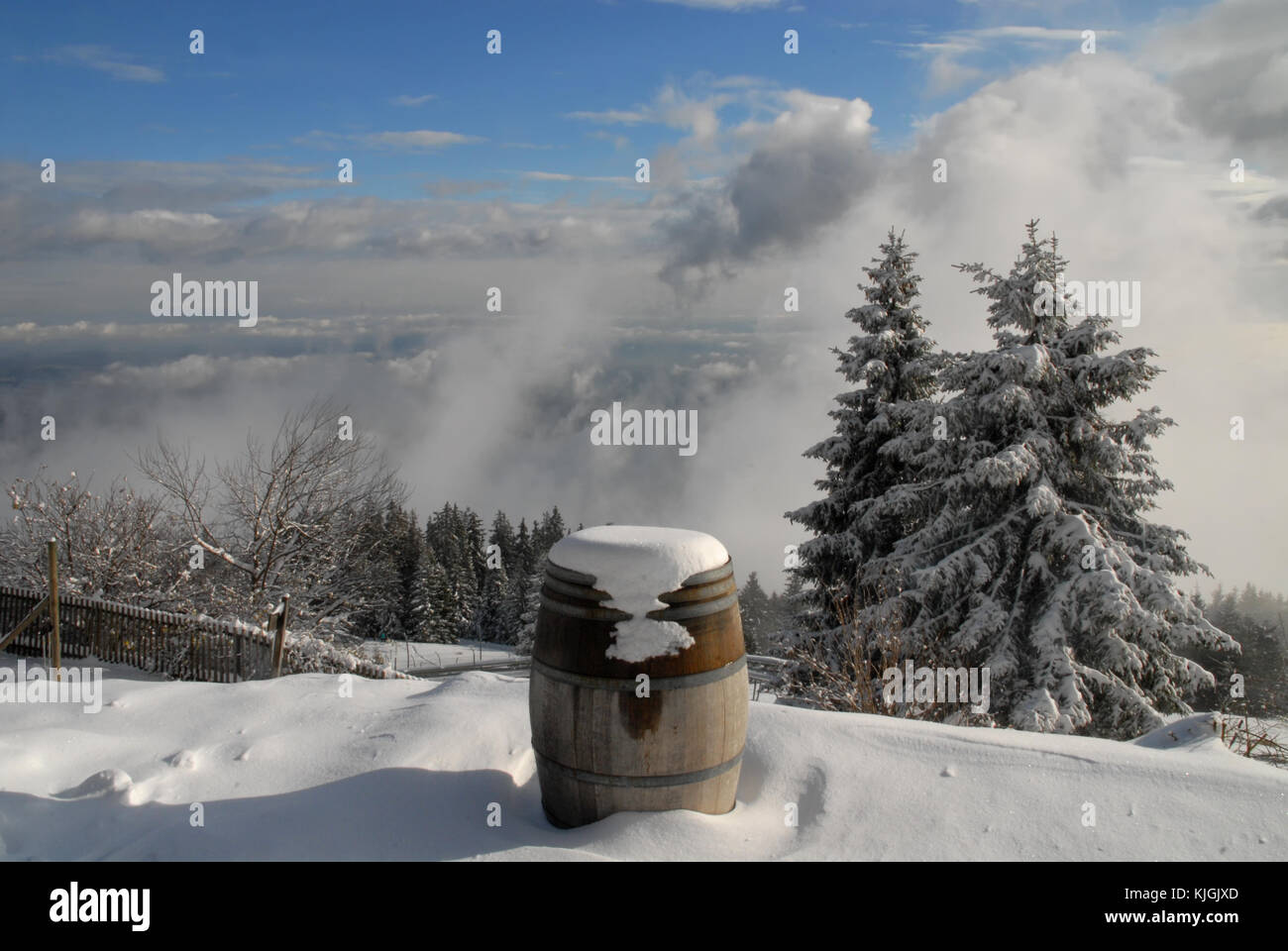 Snowbound barrel on top of the mountain Schöckl near Graz, Austria and view over clouds Stock Photo