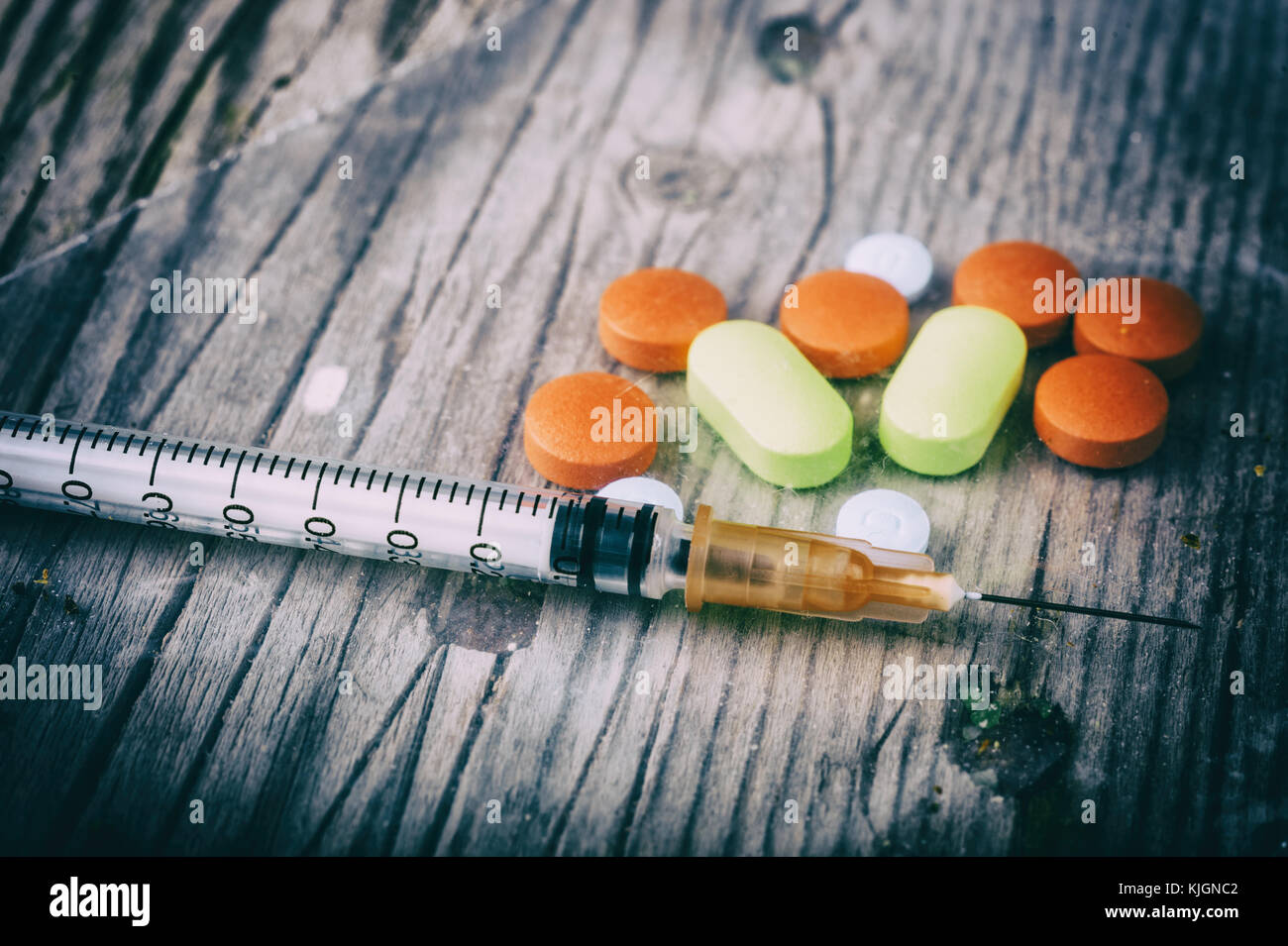 Drug addiction and chemsex illustration with syringe and pills Stock Photo
