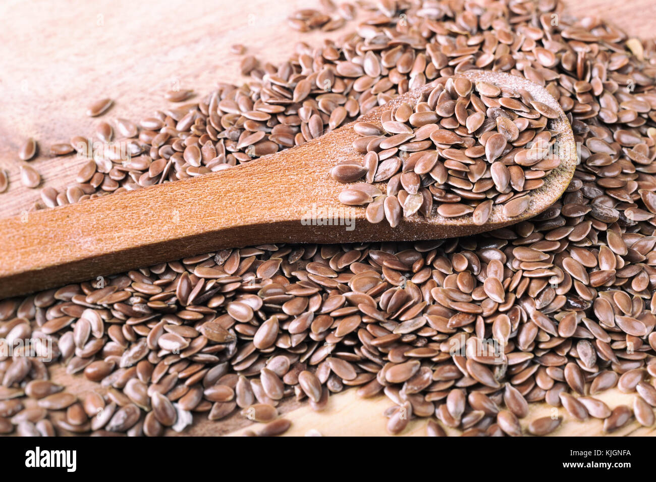 Flax seeds in wooden spoon on a board Stock Photo