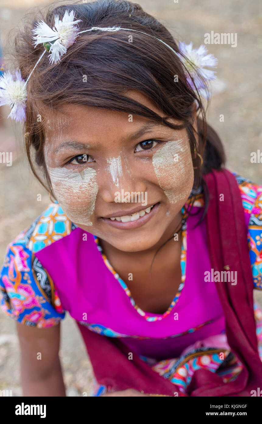 MANDALAY, MYANMAR - MARCH 12 : Unidentified Burmese girl with traditional thanaka on her face on March 12, 2016 in Mandalay, Myanmar.Thanaka is a yell Stock Photo