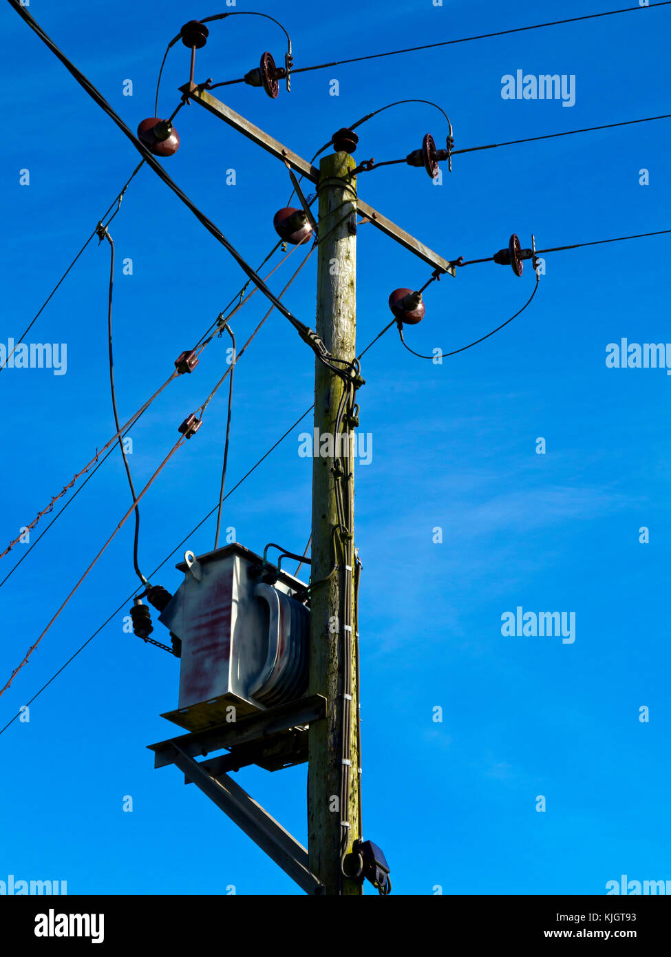 Close up view of  wooden electricity pole with power cables. Stock Photo